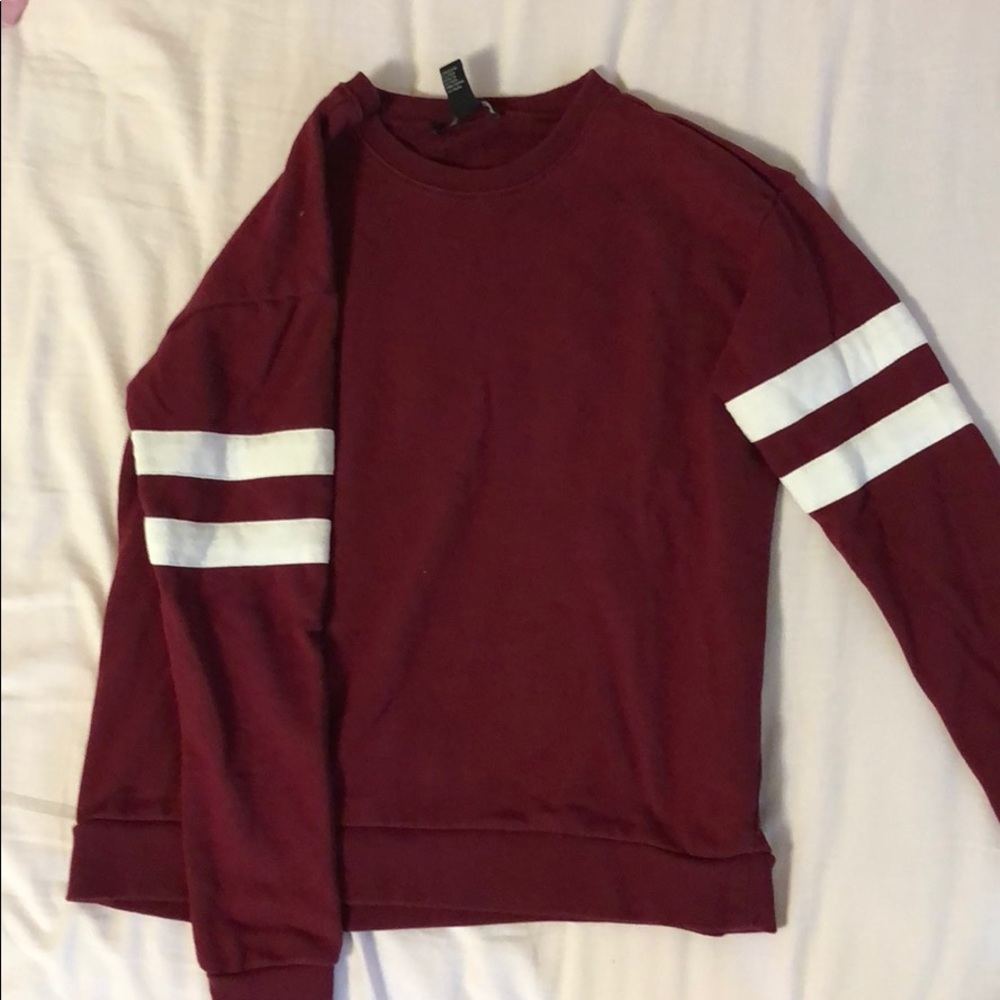 Maroon sweater with stripes on sleeve